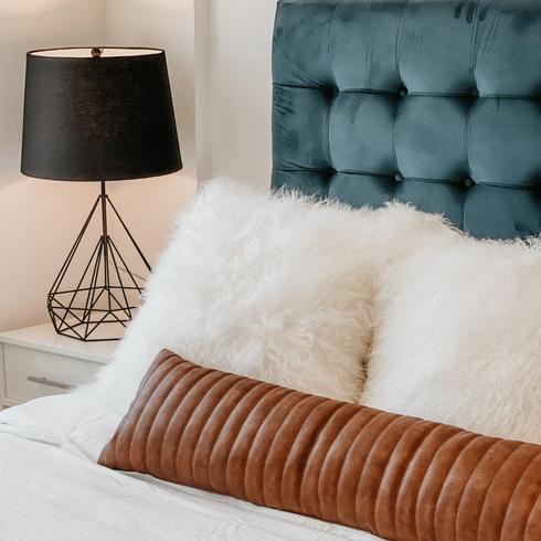 5. Lint Rollers Clean More Than Lint a white bedsheet with blue sideboards and a black lampshade