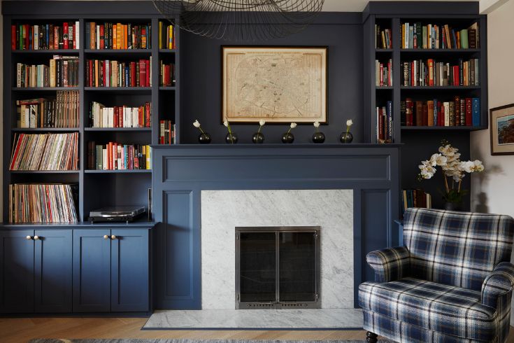 Chair Affair Colour-drenched living room with fireplace and plaid chair