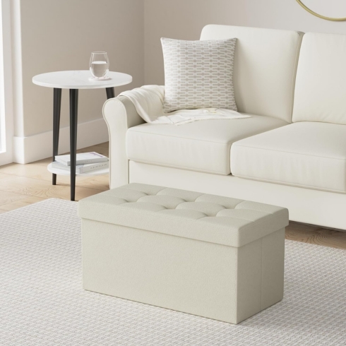 Multipurpose Seating White folding bench in front of a white sofa.