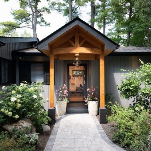 Line Your Walkway The front entrance to a rustic Canadian cottage lined with plants