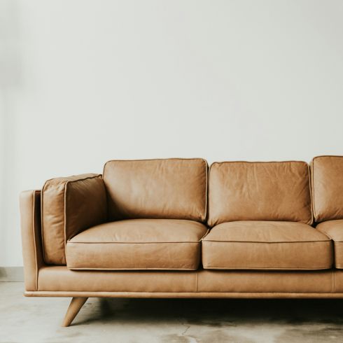 Look for Legs A tan leather couch with legs.