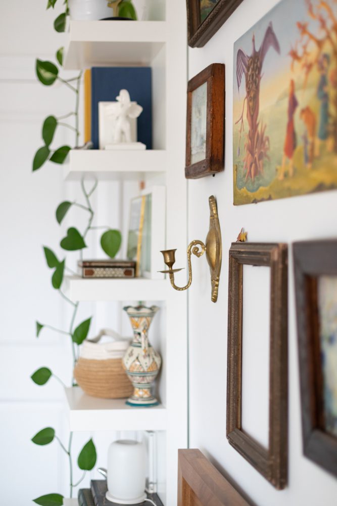 Float On Close-up of white shelves and gallery wall above bed