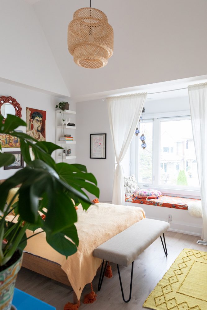 Let There Be Light cozy white bedroom with woven hanging light fixture over bed