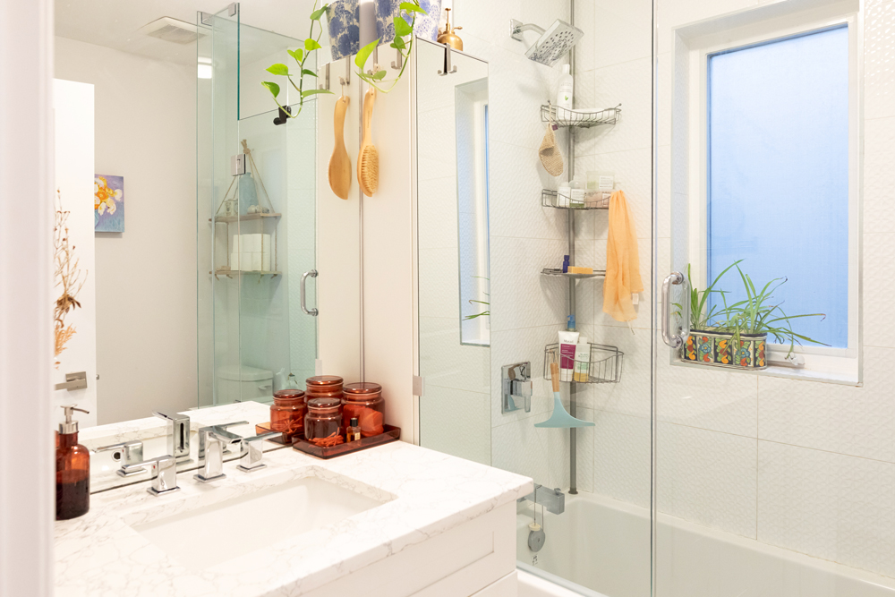 Plant Life White bathroom with glass shower door and green plants