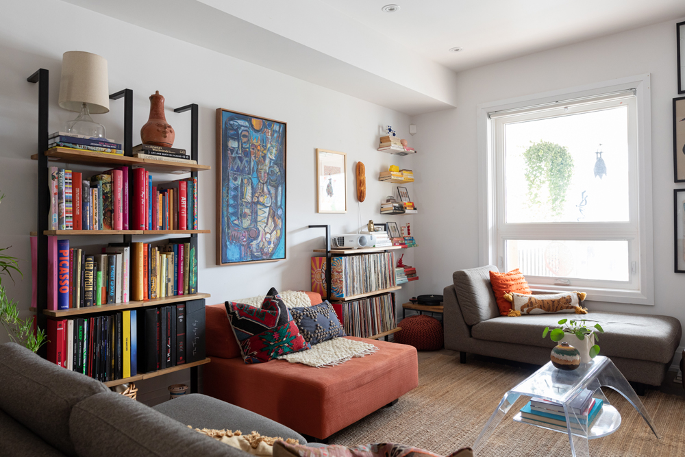 Artful Arrangement White living room with ladder shelving and chaise