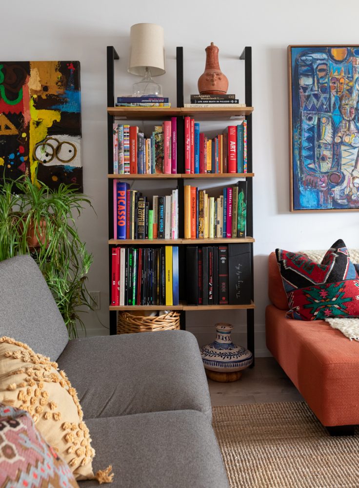 Shelf Style White living room with ladder shelving and colourful art books