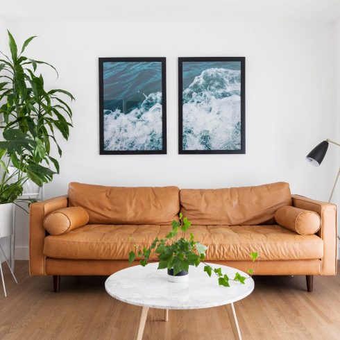 Pictures of the Great Outdoors Photography artwork of water hanging over the couch in a basement living room