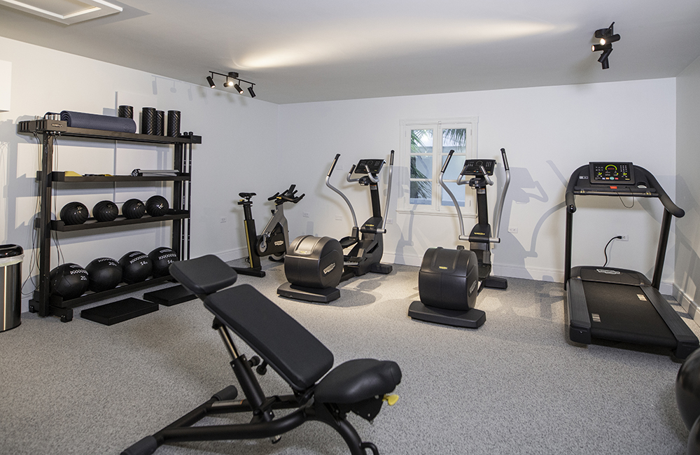 With a View Home gym with various sets of workout equipment