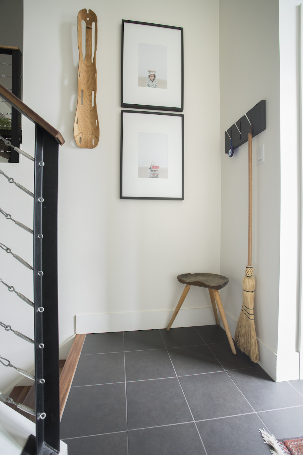 Do Maximize Smaller Spaces Corner of a hall with hooks for storage and a stool