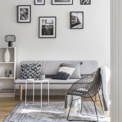 Try a Gallery Wall gallery of black and white frames on the wall of living room interior