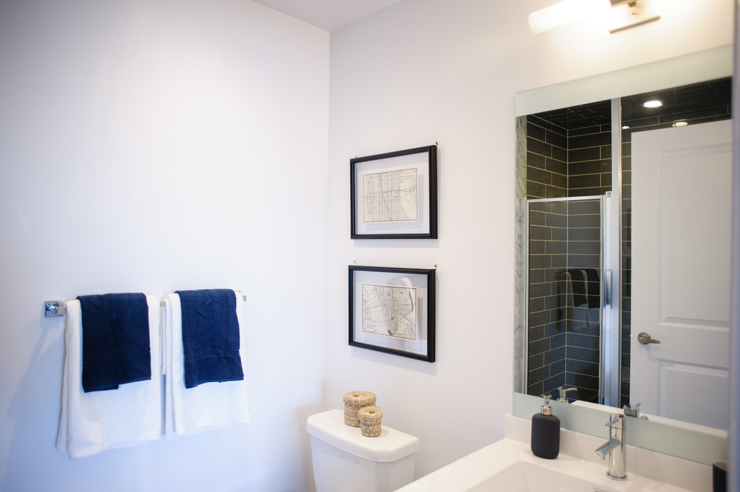 Bare Minimum Masculine guest bathroom with black subway tile shower