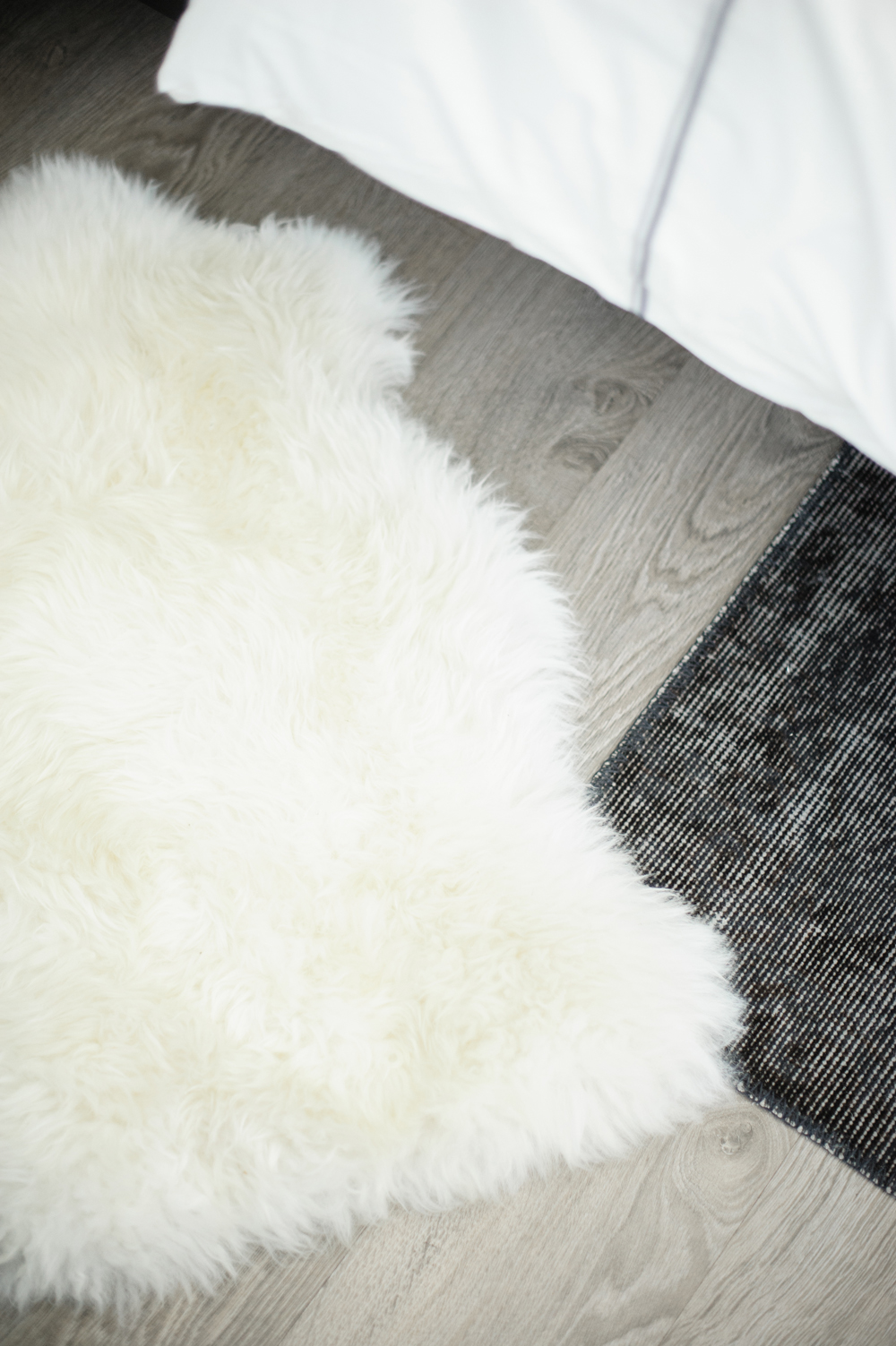 Layered Textures Sheepskin throw and rug over hardwood floor