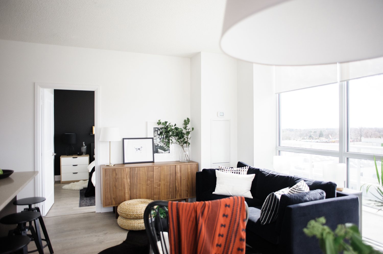 The Bright and Beautiful Living Room Black and white living room with a red throw