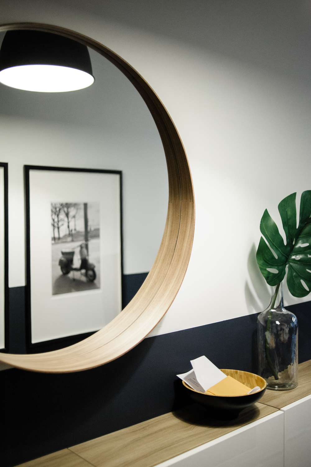 The Mirror of All Mirrors Round mirror hung over hallway console table