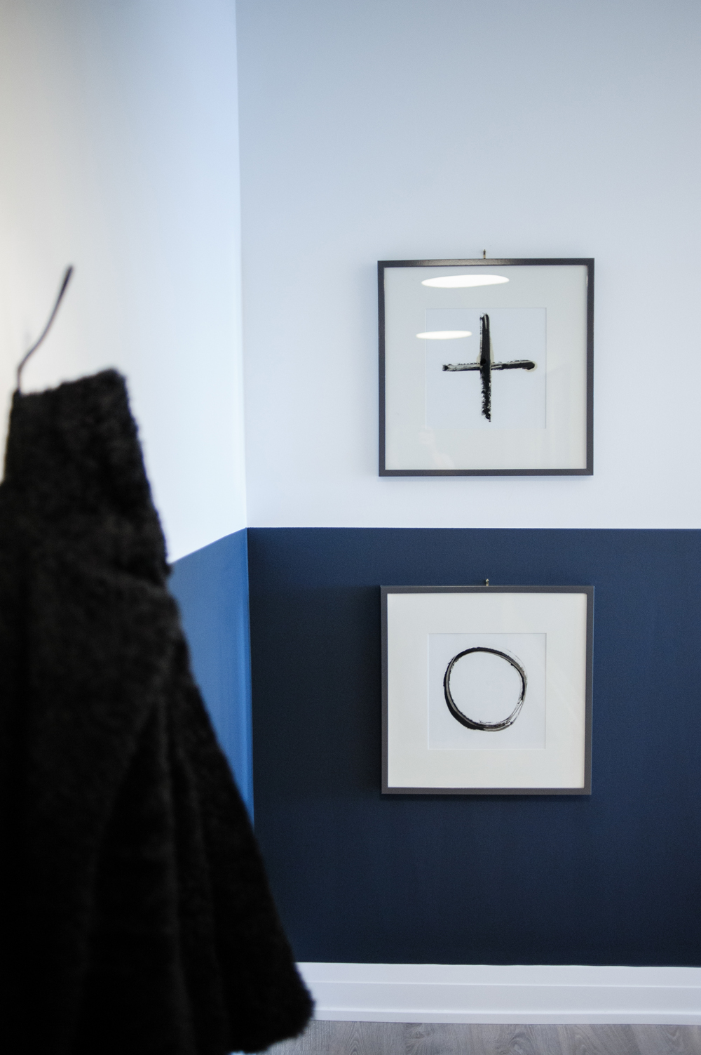 Opposites Attract Black and white prints hung on a wall