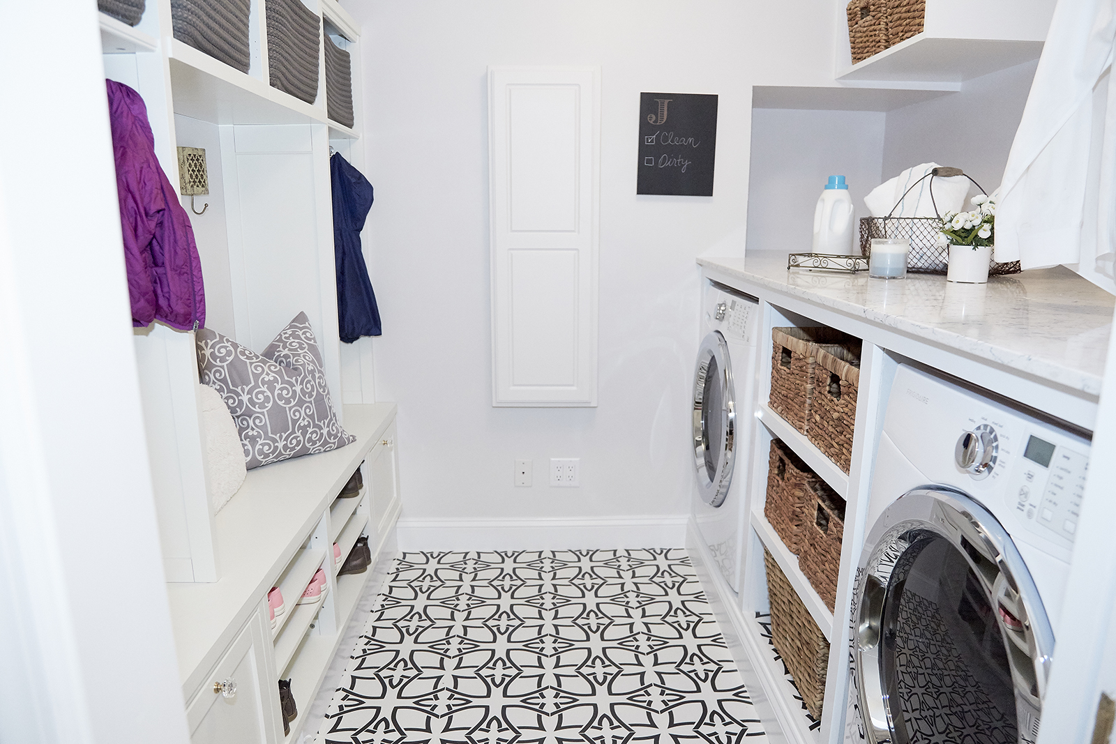 Take The Floor Modern white mudroom and laundry room design with bold floor tiles.
