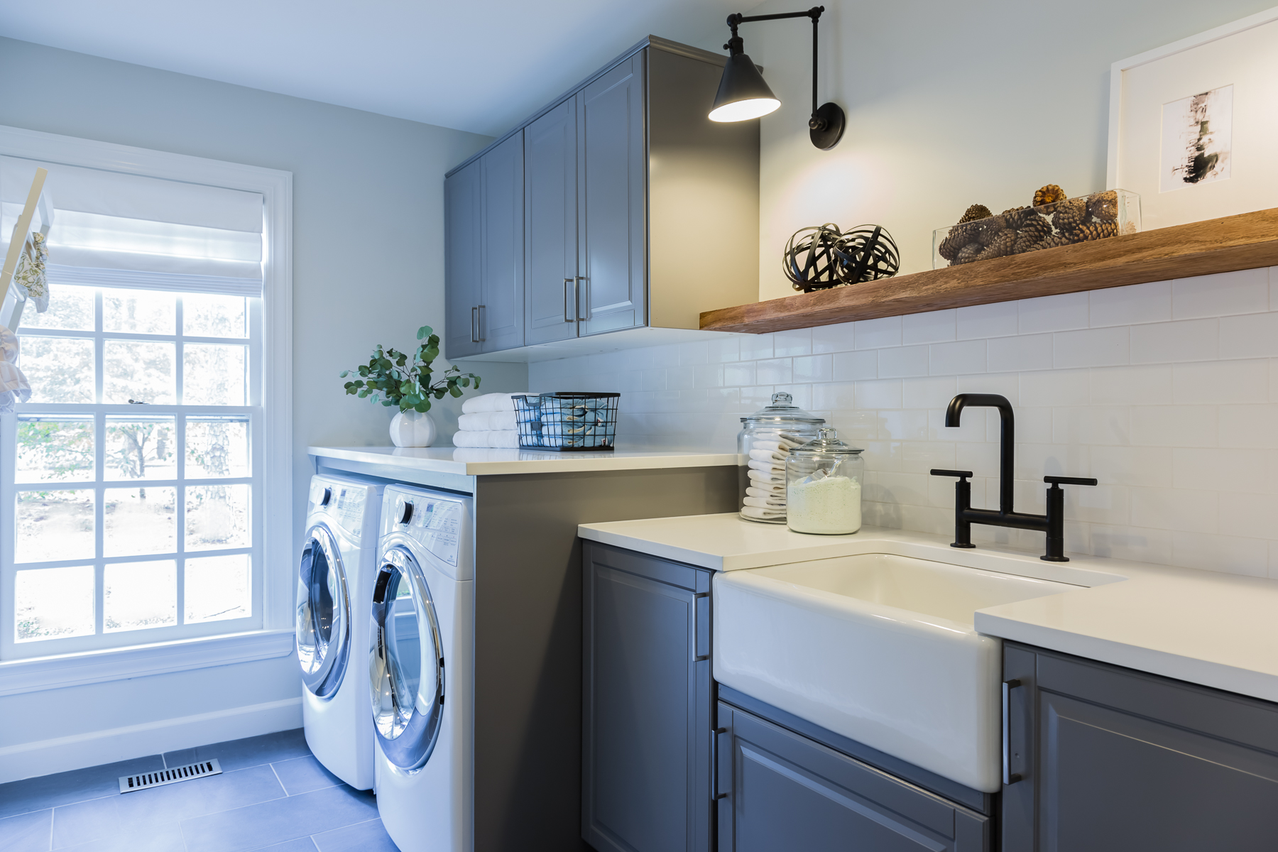 So Fresh Sleek modern laundry room design with subway tile backsplash.