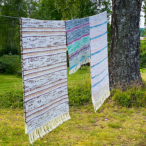 Beat the Dust Away Rag rugs on clothes line in garden. Countryside. Rustic. Swedish summer.