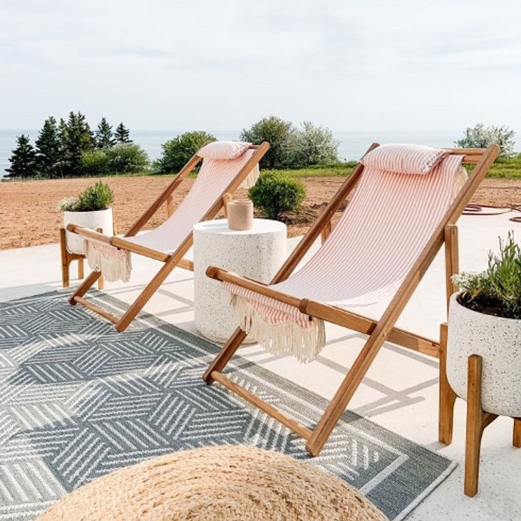Rinse Your Outdoor Rug pink chairs on rug outside