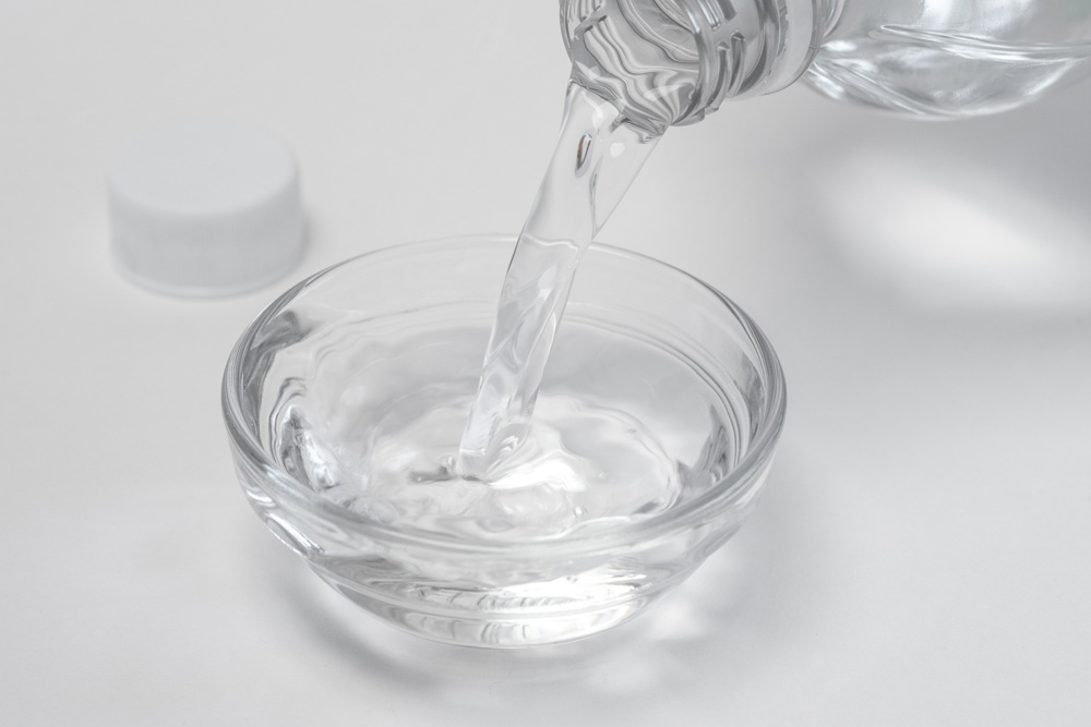 Hydrogen Peroxide and Vinegar pouring vinegar into a bowl