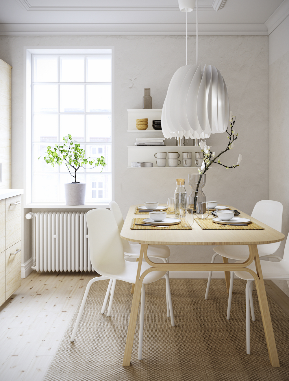 Pretty Quartet IKEA birch dining table with four white chairs in kitchen