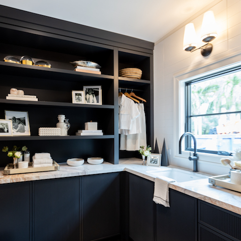 A Redesigned Laundry Room Dark laundry room with storage