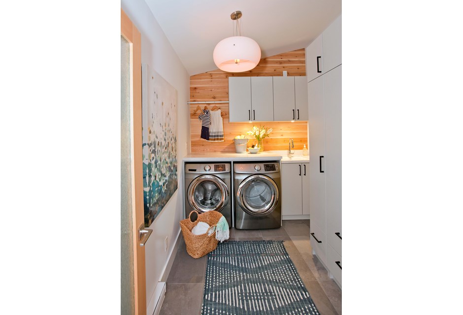 Natural Beauty Wooden laundry room design with blue runner and lots of storage.