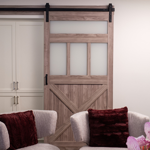 Open the Door A sliding barn door covers a white cabinet area