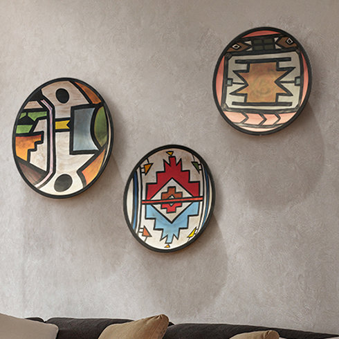 A Clean Plate Three graphic patterned plates hung on a living room wall