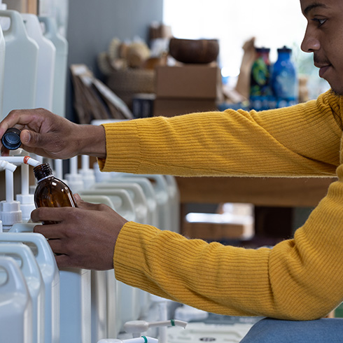 Low-waste Homes Person refilling bottles
