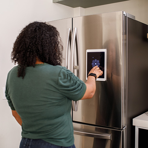 More Proactive Smart Tech Person using a smart fridge - future home trends