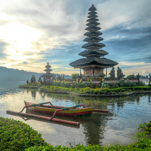 Bali, Indonesia A canoe on a lake in Bali, Indonesia with a Hindu temple on the shore.