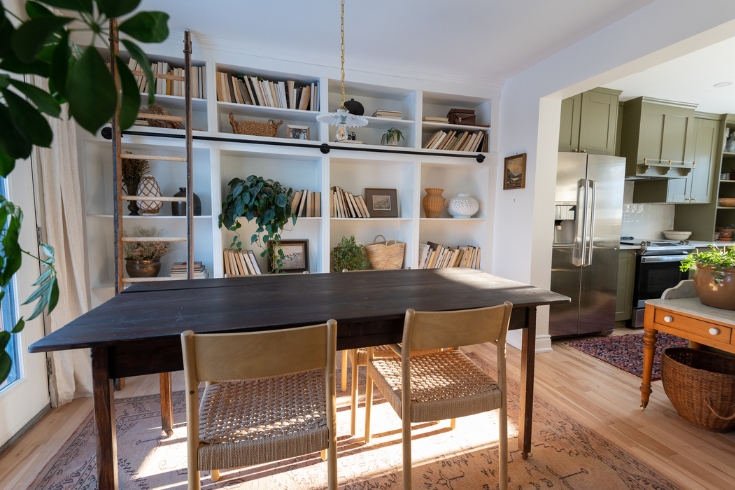 DIY Dining Room A dining room with large table with four chairs and built-in bookcases along one wall
