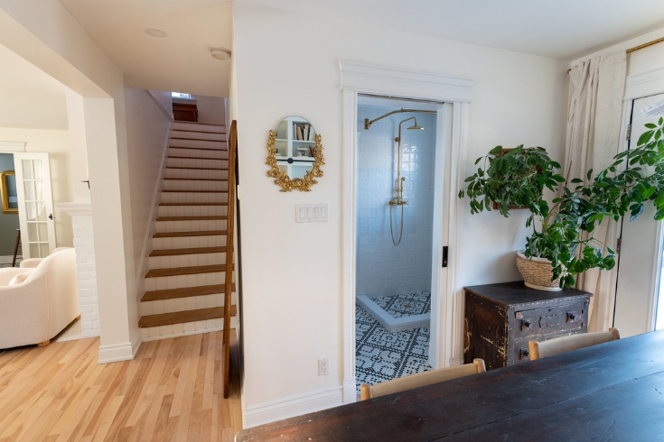 Beneath Your Feet A staircase, bathroom entrance and part of a dining room with light-toned hardwood flooring