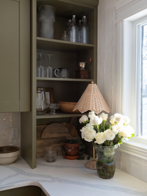 Bespoke Beauty A kitchen corner with green cabinetry and open shelving