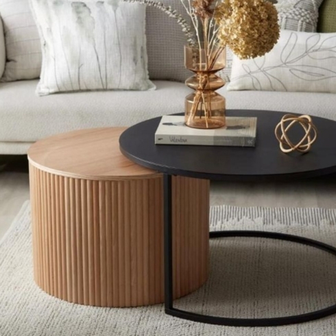 Find the Right-Sized Furniture for the Space Nesting coffee table with black metal top and natural wood.