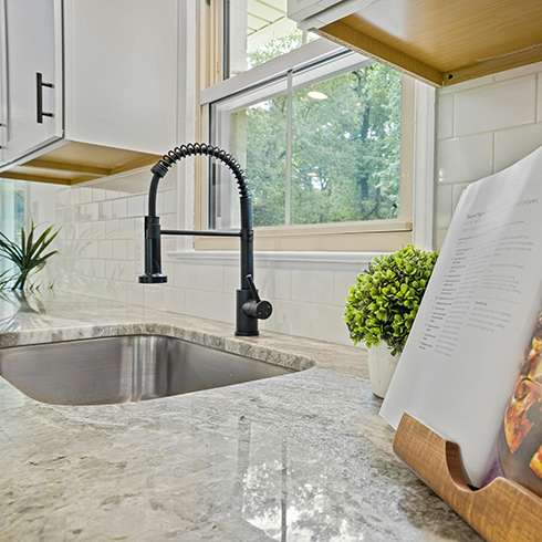 Marble, Granite or Natural Stone Shot of a granite countertop and sink alongside an open cookbook