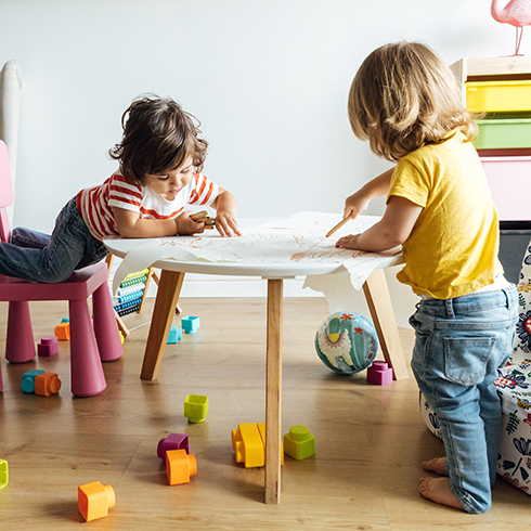 Avoid Areas Where Kids and Pets Play Side view preschool kids playing drawing in modern table with small armchair while spending time together in playroom of modern kindergarten. Children learning concept