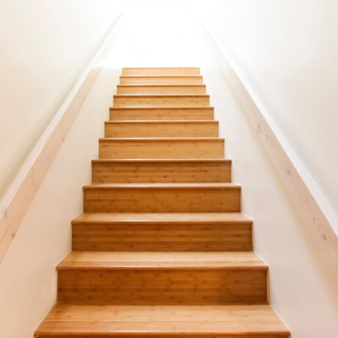 Uneven Steps or Sidewalks Wood steps leading upstairs with white walls