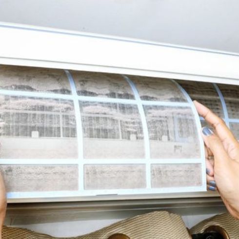 Outdated HVAC Systems Old air conditioning unit filter being changed