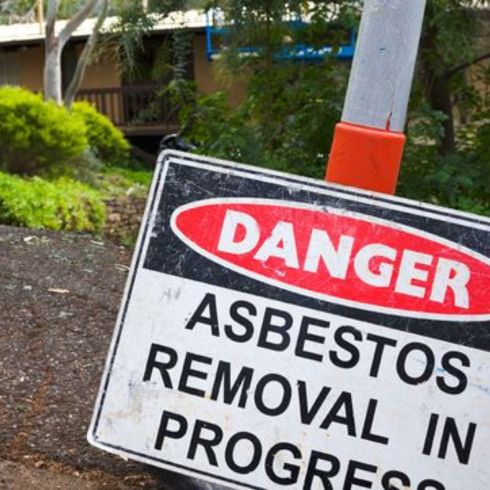 Asbestos Asbestos warning sign on home