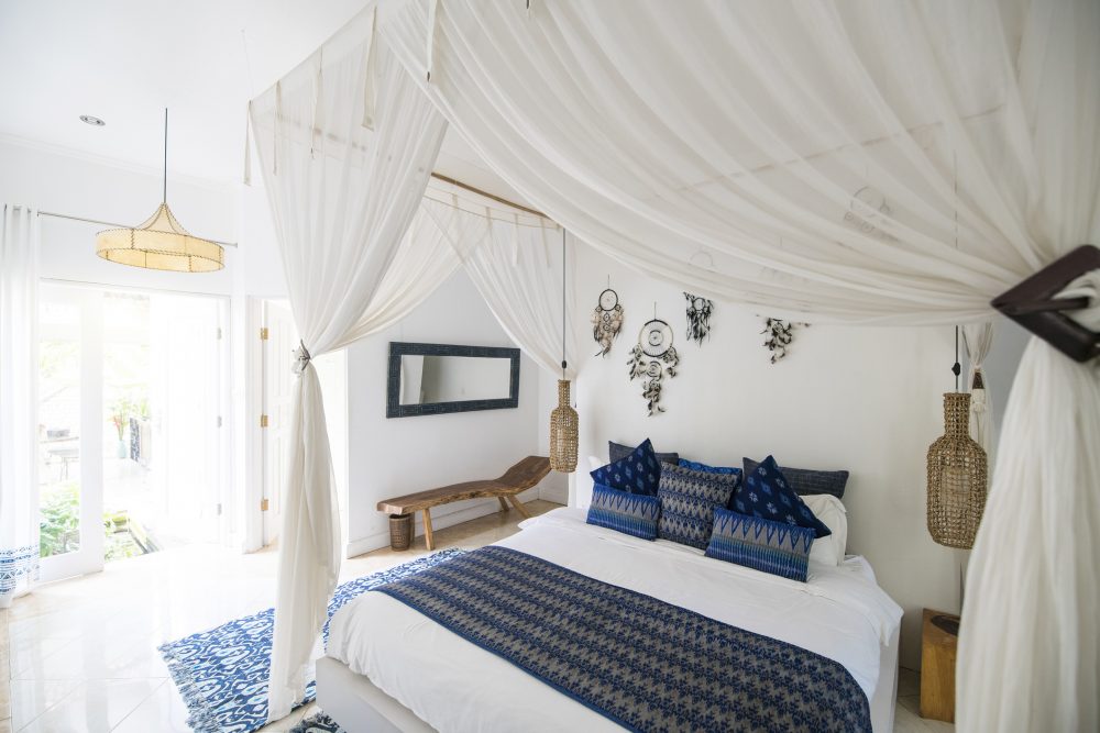 Curtain Call white bedroom with white curtains around bed