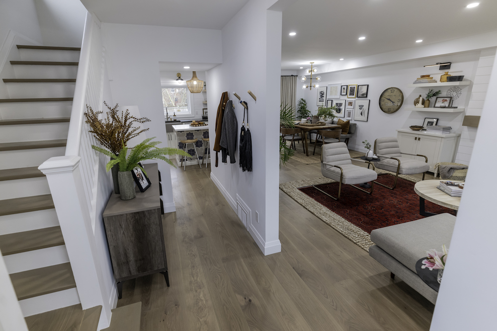 Cut a Rug open front entrance with hooks on wall and view of living room, dining room and kitchen