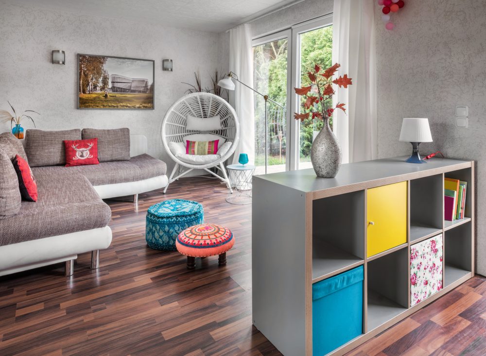 Shelf Preservation grey shelving unit with colourful boxes in open-concept living room