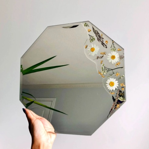 Painted Mirror A unique-shaped mirror painted with daisies.