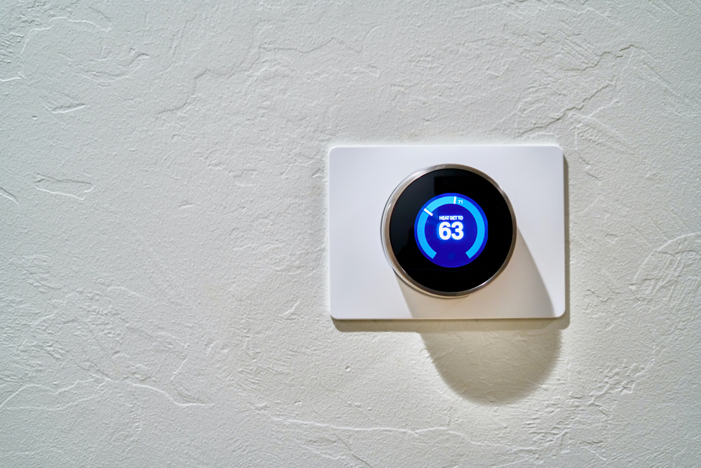 2. Get a Programmable Thermostat Modern thermostat on a wall in a house