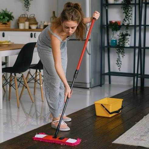 Simplify Your Tasks Woman cleaning floors with a red mop