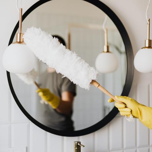 20 Minute Cleaning Routines Woman dusting bathroom
