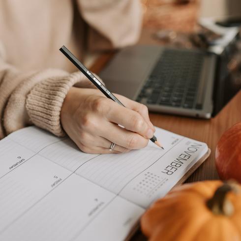 Make A Cleaning Schedule Person writing down cleaning schedule with 10 minute cleaning routines