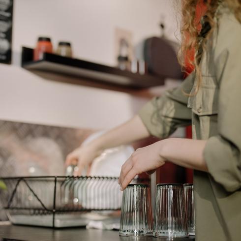 Feeling Inspired Woman putting dishes away